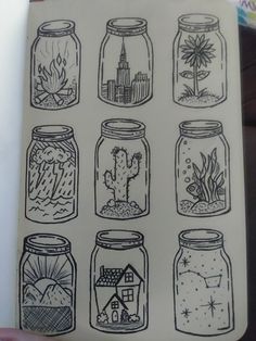 a notebook with some drawings on it and many jars filled with plants, rocks and houses