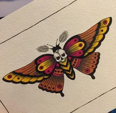 a close up of a butterfly on a piece of paper