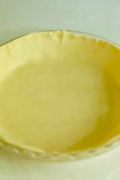 a yellow bowl sitting on top of a white counter