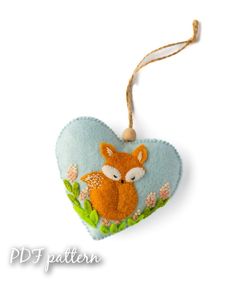 a heart shaped ornament with a fox on it