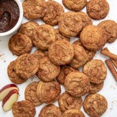 some cinnamon cookies and an apple are on the table