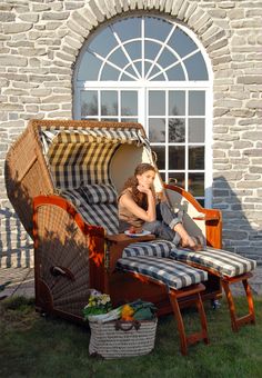 a woman is sitting in an outdoor chair