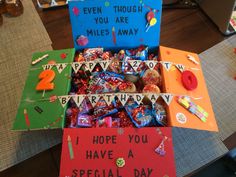 a box filled with lots of candy on top of a table next to other boxes