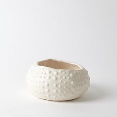 a white ceramic bowl sitting on top of a table