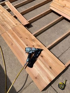 a drill is laying on top of some wood planks that have been built into the floor