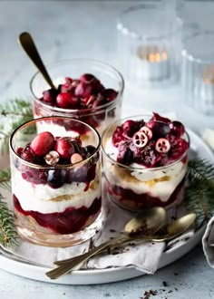 two desserts with cranberry sauce and whipped cream on a white platter