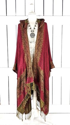 "Hooded burgundy and gold border paisley pashmina kimono cover up jacket with optional fringe detail Measurements...taken flat - width across seam to seam: 46\" - regular length with fringe: 38\" - regular length without fringe: 34\" Features... - lovely soft woven medium weigh pashmina fabric - bohemian oversized flowing design - cardigan style with an open front and generous arm holes - attached hood - universal design allows a comfortable fit for small through plus sizes - the perfect layerin Hooded Kimono, Fall Bohemian Pashmina Shawl In One Size, Red Fringed Shawl For Fall, Red Shawl Wrap For Fall, One Size Pashmina Shawl For Fall, Red Fringe Shawl For Fall, Bohemian Pashmina Shawl For Fall, Winter Bohemian Pashmina Shawl With Traditional Drape, Bohemian Pashmina Shawl With Traditional Drape For Winter