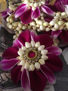 purple and white flowers with pearls on them