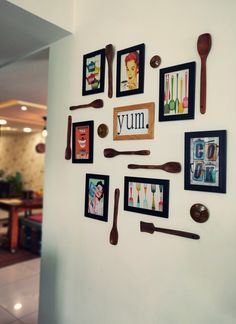 a wall with pictures and utensils on it