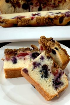 slices of blueberry cheesecake on a white plate next to a loaf of bread