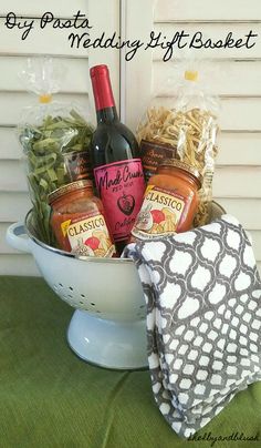 a white bowl filled with lots of food next to a bottle of wine and napkin