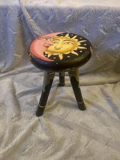 a small stool sitting on top of a bed