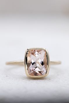 14k Yellow Gold and Pink Beryl Solitaire, Cushion Cut Statement Ring, Diamond Alternative Engagement Morganite gems exhibit the pleochroism effect that exhibits different colors when viewed from different angles. Here are the details on this one: The color is a light pink/lavender and measures 7mm x 9mm and weighs approximately 2.5 carats. The handmade setting is 14k yellow gold with subtle facets along the slender band. Morganite is a 7.5 on the MOHS scale and exhibits a glowing affect in low l Unique Morganite Engagement Ring, Morganite Engagement Ring Yellow Gold, Modern 14k Gold Topaz Ring, Modern 14k Gold Topaz Ring With Center Stone, Modern 14k Gold Topaz Wedding Ring, Modern 14k Gold Topaz Ring With Prong Setting, Modern Topaz Ring In 14k Gold With Prong Setting, Modern 14k Gold Topaz Ring With Bezel Setting, Modern 14k Gold Bezel Set Topaz Ring