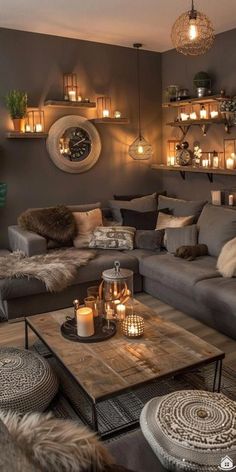 a living room filled with lots of furniture and candles on top of the coffee table