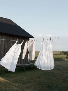 clothes hanging out to dry in front of a barn