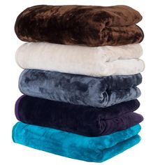 four towels stacked on top of each other in different colors and sizes, with one folded up