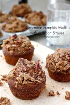 cinnamon pumpkin muffins with pecan streuse are on a cutting board