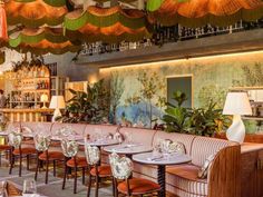 the interior of a restaurant with many tables and chairs