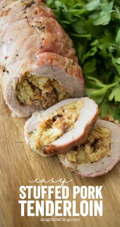 stuffed pork tenderloin on a cutting board with parsley