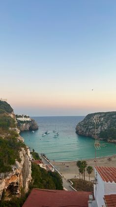 a view of the beach and ocean from an overlook point on a sunny day with boats in the water