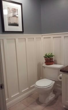 a white toilet sitting in a bathroom next to a sink