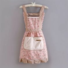 a pink and white apron hanging on a wall