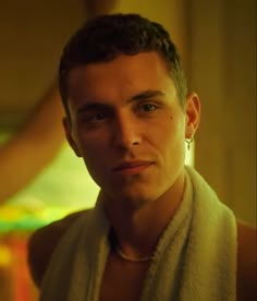 a man in a towel looking at the camera