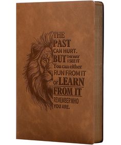 a brown leather book with an image of a lion on it's front cover