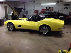 a yellow sports car parked in a garage