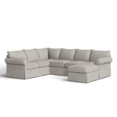 a large sectional couch sitting on top of a white floor next to a chair and ottoman