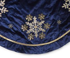 a blue and gold snowflake is shown on the back of a dress with sequins