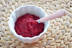 a small white bowl filled with red food