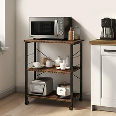 a microwave oven sitting on top of a wooden shelf