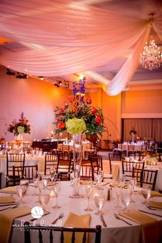 the tables are set for an event with tall centerpieces