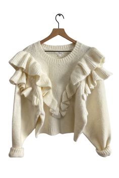 Details Make a statement this fall with the ruffled Versace in Mind Sweater in ivory. Large knit ruffles form a v-shape down the front and around the shoulders, made with the softest knit material. Pair this sweater with your favorite floral skirt or tuck it into high-waisted pants for a chic outfit! Knit ruffle detailing Crew neckline Ribbed cuffs and hemline Color: Cream Fabric + Fit 70% Acrylic, 27% Nylon, 3% Spandex Fit is true to size XS (2-4), S (6-8), M (10-12), L (12-14) Imported Measure Sweater With Ruffles, Knit Ruffles, Outfit Knit, Crochet Tulip, Hyper Feminine, Church Clothes, Work Outfit Ideas, Preppy Fashion, Preppy Clothes