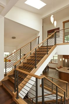 an open floor plan with stairs and railings