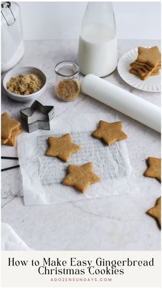 homemade gingerbread cookies on parchment paper with milk and cookie cutters in the background