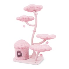 a pink toy tree house with clouds on top