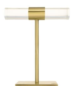 a gold table lamp with a glass shade on it's base and a white light in the middle