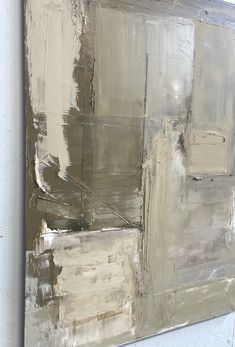 an abstract painting with white and grey colors on the wall, including squares in different sizes