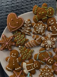 a white plate topped with lots of different types of gingerbreads on top of a table