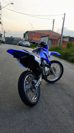 a blue and black motorcycle parked on the street