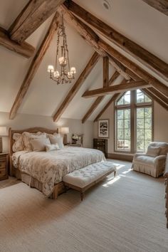 a bedroom with a large bed in the middle of it and a chandelier hanging from the ceiling