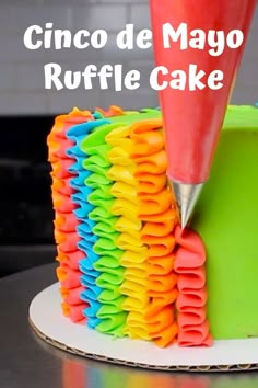 there is a cake that has been decorated with many different colored icing on it