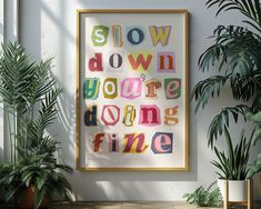 there is a framed poster with the words slow down you're doing fine on it