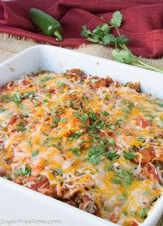 a casserole dish with meat, cheese and vegetables in it on a table