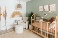 a baby's room with a crib, rocking chair and other items in it