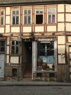 an old building with lots of windows and wooden trimmings on the front door