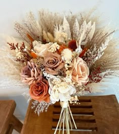 a bouquet of flowers sitting on top of a wooden table