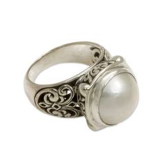 A silvery-white mabe pearl the June birthstone is embraced by grace and beauty in this elegant cocktail ring by Kadek Hendra. The ring features ornate Balinese-style silver work on the sides and bezel..925 Sterling silver Elegant White Domed Rings, Elegant White Domed Jewelry, Elegant Domed Moonstone Ring, Classic White Cabochon Moonstone Ring, White Domed Anniversary Rings, White Domed Rings For Anniversary, White Domed Jewelry For Anniversary, Classic Silver Cabochon Pearl Ring, Elegant White Moonstone Ring With Intricate Design